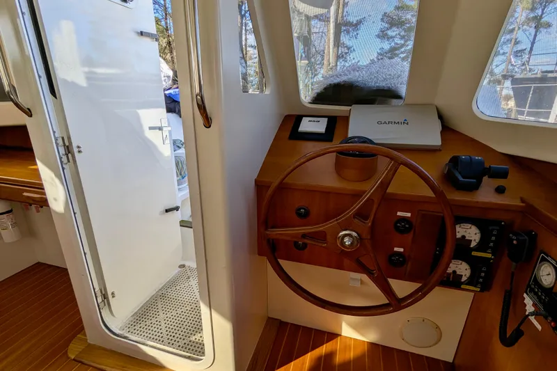 Watermark Yacht Photos Pics Interior helm of 2003 Chris White Atlantic 42 with wooden steering wheel and navigation equipment.