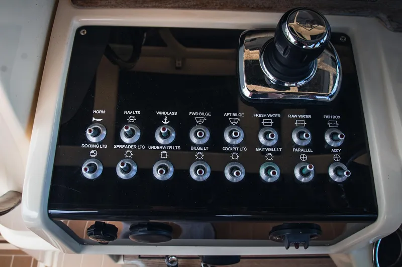  Yacht Photos Pics Control panel of a 2017 Chris-Craft Catalina 34 boat with various switches and a joystick.