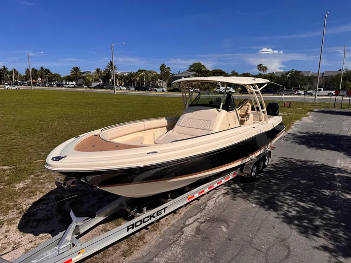  Yacht Photos Pics 2017 Chris-Craft Catalina 34 boat on trailer, parked outdoors under clear blue sky.