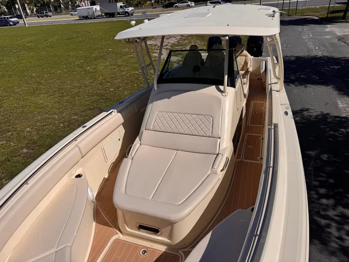  Yacht Photos Pics 2017 Chris-Craft Catalina 34 boat with beige seating and wooden deck, parked on grass.