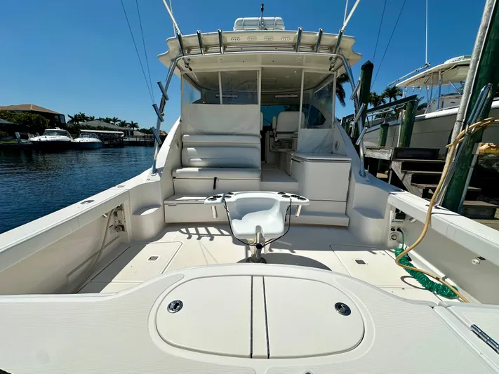  Yacht Photos Pics 2018 Tiara Yachts 4300 Open, spacious deck, luxurious seating, docked by waterfront.
