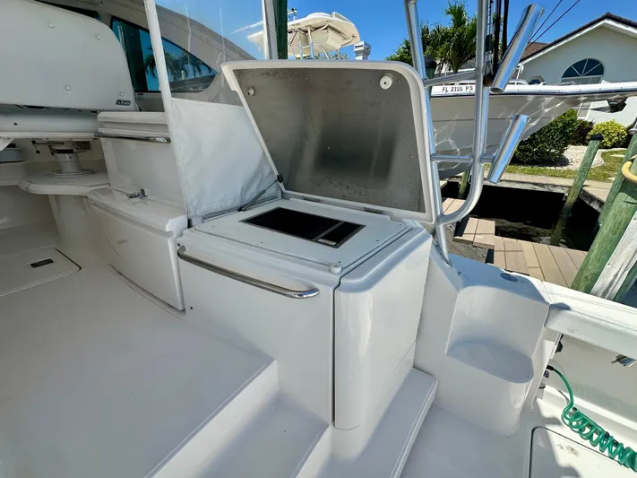  Yacht Photos Pics 2018 Tiara Yachts 4300 Open cockpit with open storage compartment and sleek white design.