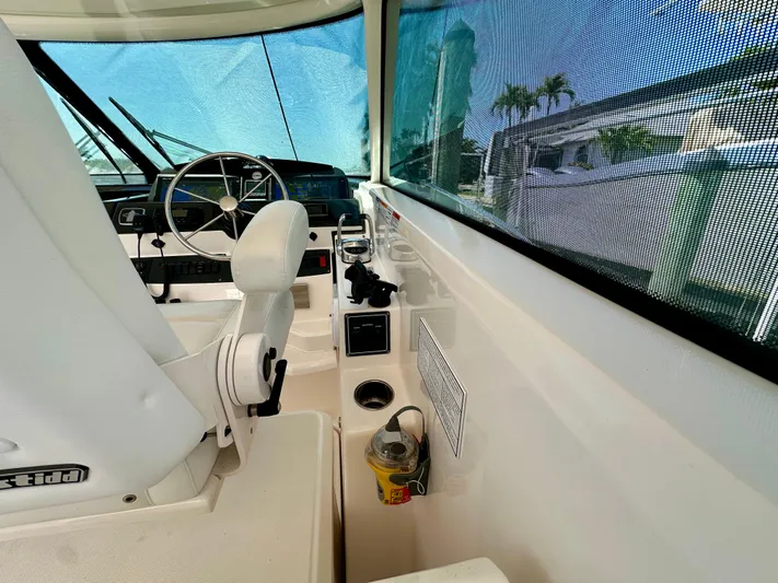  Yacht Photos Pics 2018 Tiara Yachts 4300 Open helm with steering wheel and controls, featuring a sleek design.
