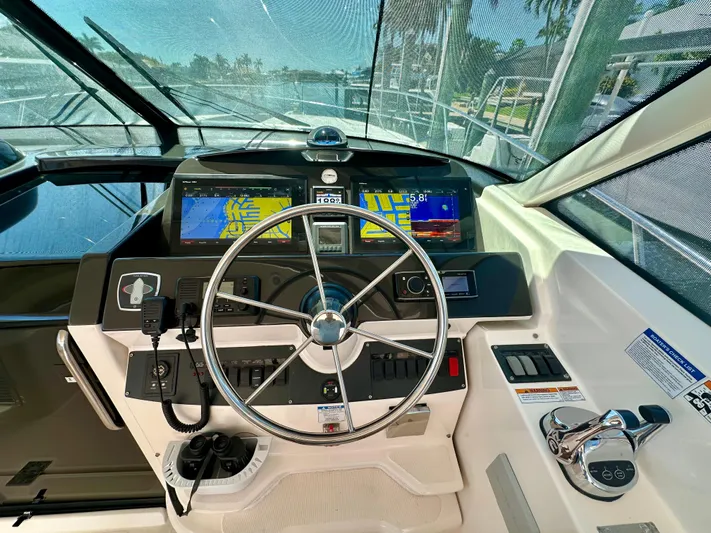  Yacht Photos Pics 2018 Tiara Yachts 4300 Open helm with navigation screens and steering wheel.