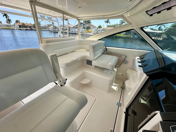  Yacht Photos Pics 2018 Tiara Yachts 4300 Open interior with white seating and waterfront view.
