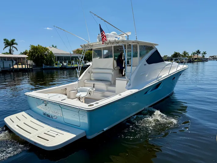  Yacht Photos Pics 2018 Tiara Yachts 4300 Open cruising on a sunny day in a scenic waterway.