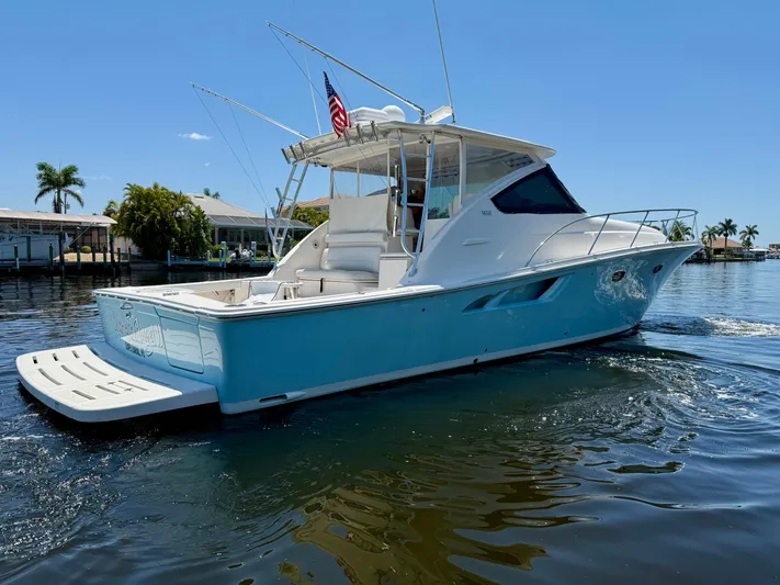  Yacht Photos Pics 2018 Tiara Yachts 4300 Open cruising on a sunny day, featuring sleek design and vibrant blue hull.