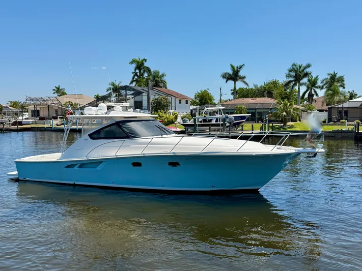  Yacht Photos Pics 2018 Tiara Yachts 4300 Open cruising on a sunny day near waterfront homes.