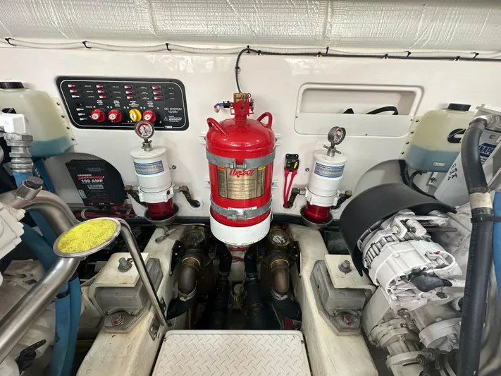  Yacht Photos Pics Engine room of 2018 Tiara Yachts 4300 Open with fire suppression system and control panel.