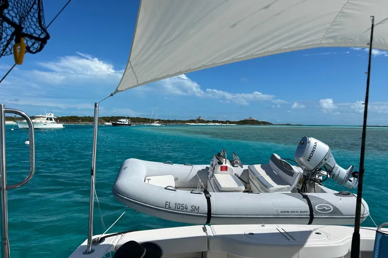  Yacht Photos Pics Tiara Yachts 4300 Open 2018 on turquoise waters with inflatable boat and clear skies.