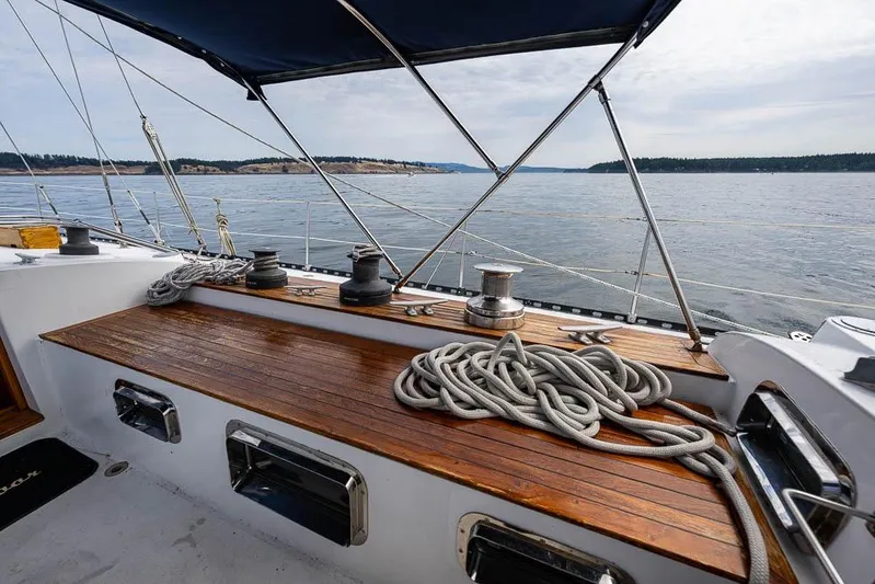 Koh -i -noor Yacht Photos Pics 1974 C&C 61 Ocean Racer/Cruiser deck with ropes and winches, sailing on calm waters.