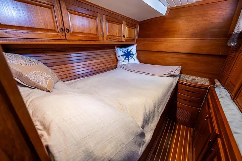 Koh -i -noor Yacht Photos Pics Cozy wooden cabin interior of 1974 C&C 61 Ocean Racer/Cruiser with bed and storage.