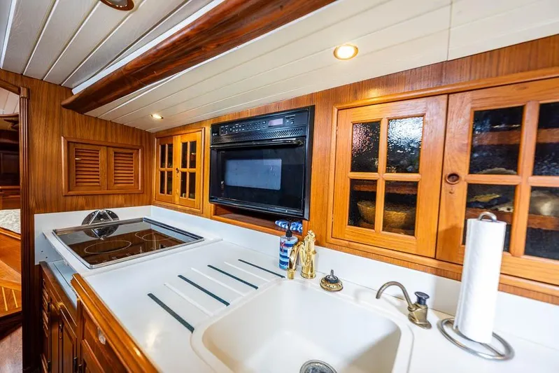 Koh -i -noor Yacht Photos Pics 1974 C&C 61 Ocean Racer/Cruiser kitchen with wooden cabinets and modern appliances.