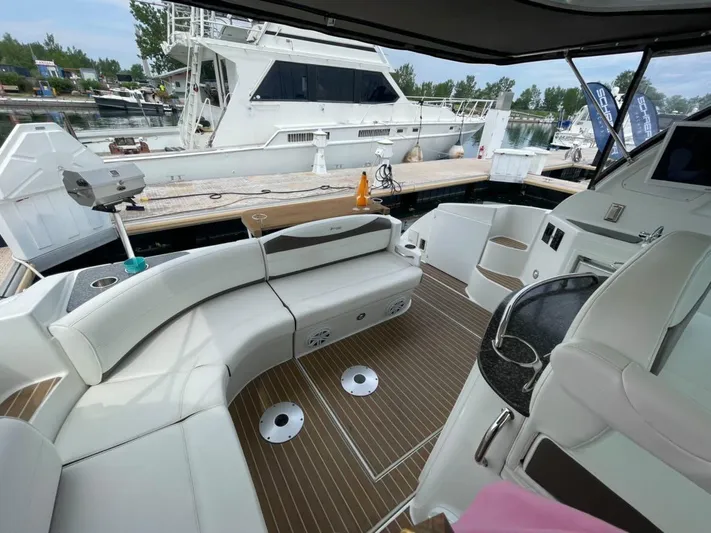  Yacht Photos Pics 2008 Cruisers 390 Sport Coupe interior with white seating and wood flooring at a marina.