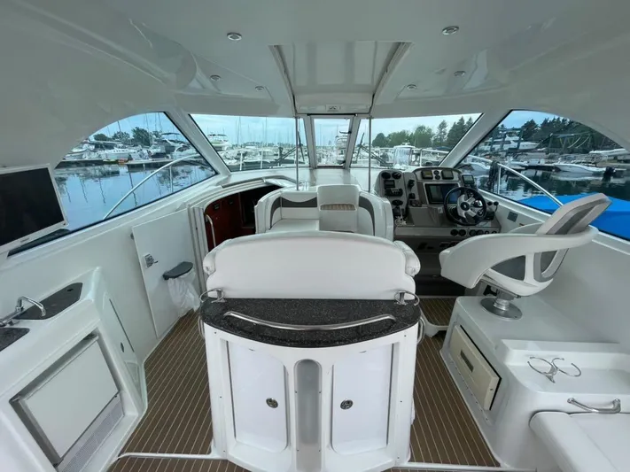  Yacht Photos Pics 2008 Cruisers 390 Sport Coupe interior with helm, seating, and marina view.