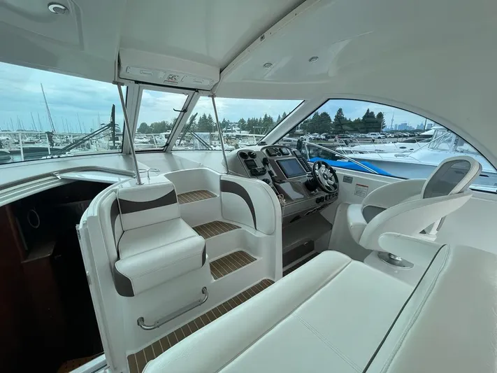  Yacht Photos Pics 2008 Cruisers 390 Sport Coupe interior with helm, seating, and marina view.