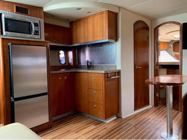  Yacht Photos Pics 2008 Cruisers 390 Sport Coupe interior with kitchen, wood cabinetry, and modern appliances.