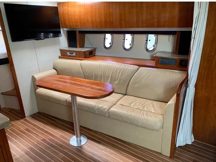  Yacht Photos Pics 2008 Cruisers 390 Sport Coupe interior with beige sofa, wooden table, and mounted TV.