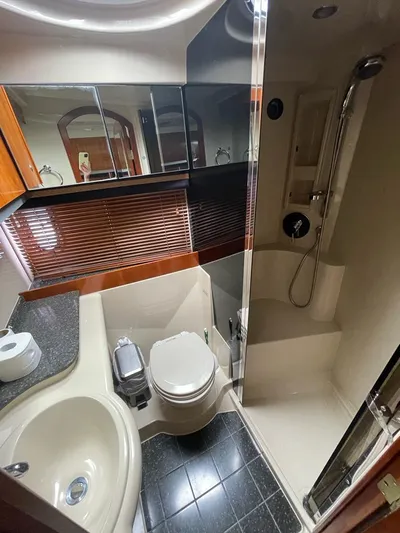  Yacht Photos Pics 2008 Cruisers 390 Sport Coupe bathroom with shower, sink, and toilet. Luxurious yacht interior.