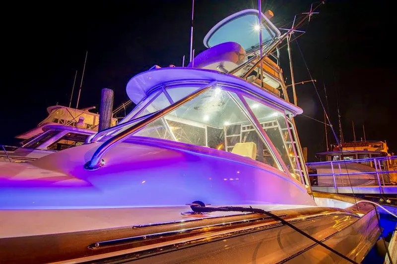 Southern Ground Yacht Photos Pics 2015 Winter Custom Yachts W-18 illuminated at night, showcasing sleek design and vibrant lighting.