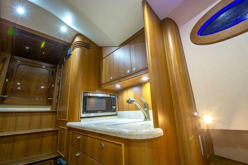 Southern Ground Yacht Photos Pics Luxurious 2015 Winter Custom Yachts W-18 interior with wood cabinetry and modern amenities.
