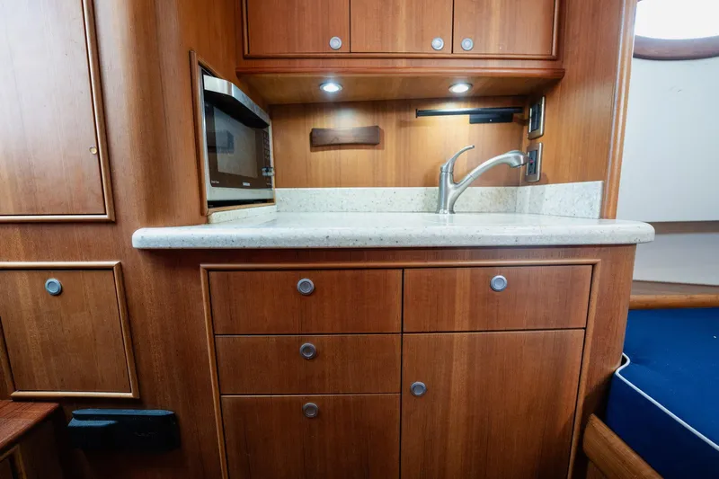 Southern Ground Yacht Photos Pics Luxurious wooden yacht kitchen interior with sink and microwave, Winter Custom Yachts W-18, 2015 model.