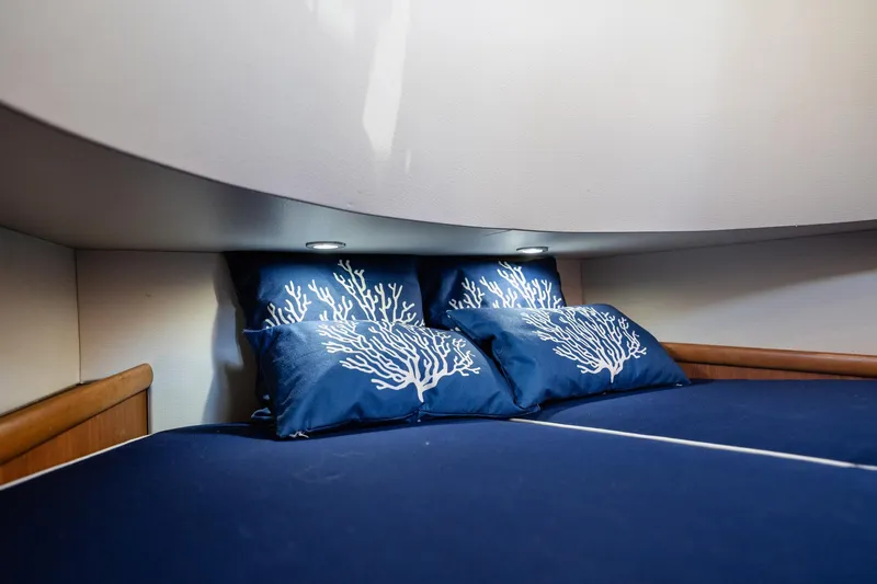 Southern Ground Yacht Photos Pics Luxurious cabin interior of 2015 Winter Custom Yachts W-18 with blue coral-themed pillows.