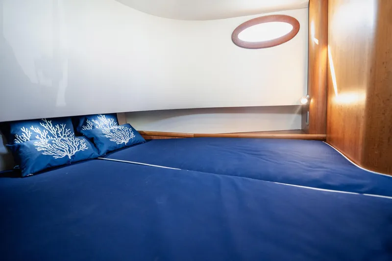 Southern Ground Yacht Photos Pics Luxurious cabin interior of 2015 Winter Custom Yachts W-18 with blue bedding.