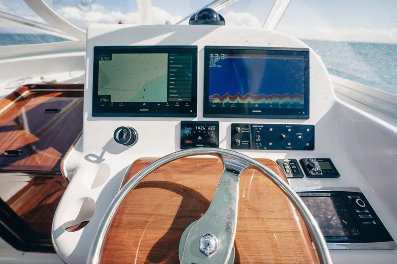 Southern Ground Yacht Photos Pics Steering wheel and navigation screens on 2015 Winter Custom Yachts W-18 boat dashboard.