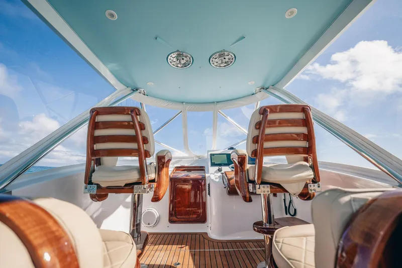 Southern Ground Yacht Photos Pics Interior of 2015 Winter Custom Yachts W-18, featuring elegant wooden helm chairs.