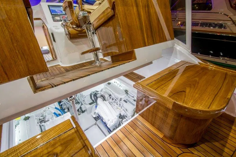 Southern Ground Yacht Photos Pics Luxurious 2015 Winter Custom Yachts W-18 interior with polished wood and visible engine compartment.