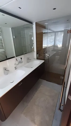  Yacht Photos Pics Luxurious bathroom in 2024 Princess X80 yacht with dual sinks and glass shower.