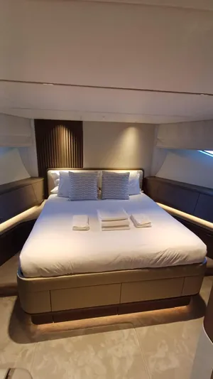  Yacht Photos Pics Luxurious bedroom interior of 2024 Princess X80 yacht with elegant bedding and ambient lighting.