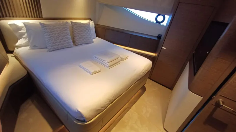  Yacht Photos Pics Luxurious bedroom interior of 2024 Princess X80 yacht with elegant bedding and modern design.