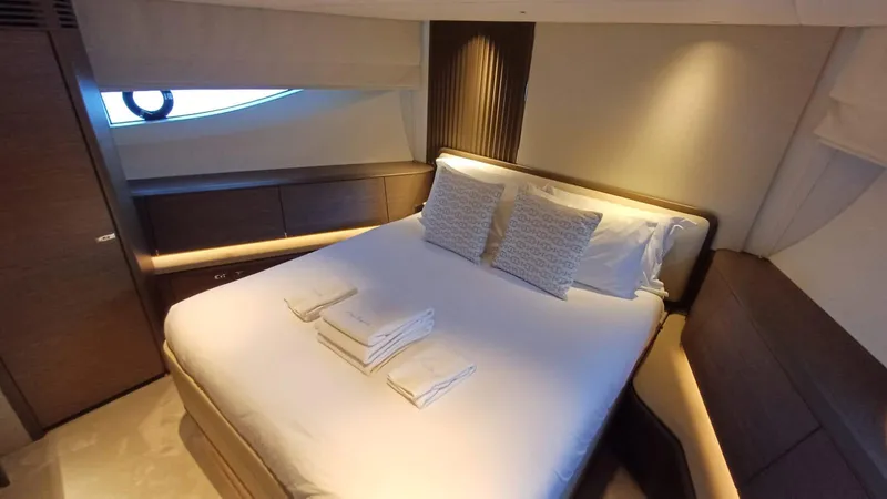  Yacht Photos Pics Luxurious bedroom interior on 2024 Princess X80 yacht with elegant bedding and ambient lighting.