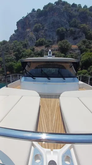  Yacht Photos Pics Luxurious 2024 Princess X80 yacht with sleek design, cruising near rocky coastline.