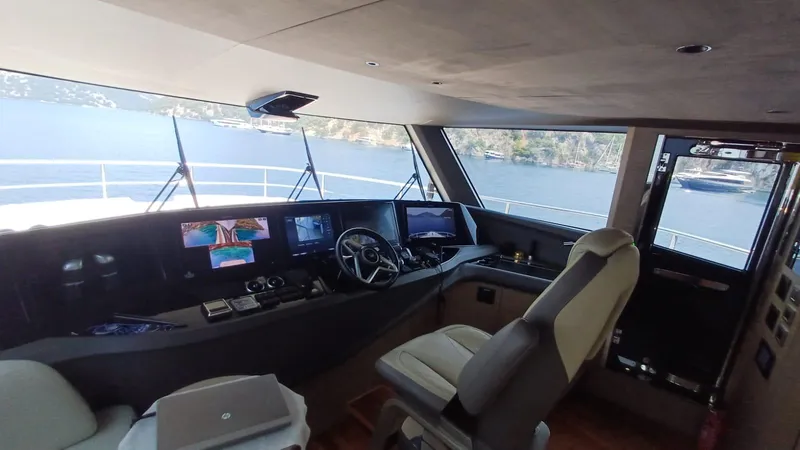  Yacht Photos Pics Luxurious 2024 Princess X80 yacht cockpit with advanced navigation systems and scenic water views.