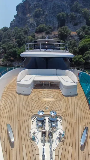  Yacht Photos Pics Luxurious 2024 Princess X80 yacht with spacious deck and elegant seating, set against scenic cliffs.