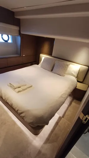  Yacht Photos Pics Luxurious bedroom interior on 2024 Princess X80 yacht, featuring elegant bedding and ambient lighting.