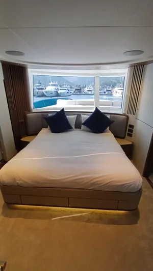  Yacht Photos Pics Luxurious bedroom interior of 2024 Princess X80 yacht with marina view.