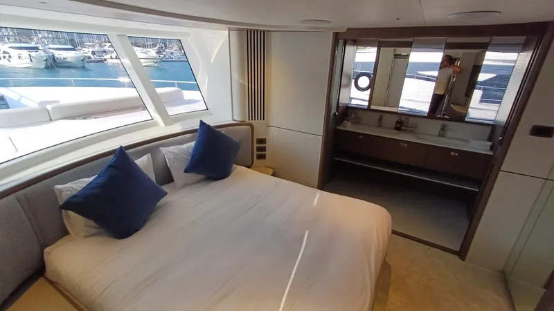  Yacht Photos Pics Luxurious 2024 Princess X80 yacht bedroom with marina view, featuring elegant design and modern amenities.