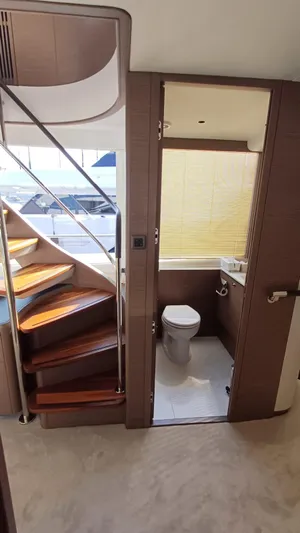  Yacht Photos Pics Luxurious 2024 Princess X80 yacht interior with wooden stairs and modern bathroom.