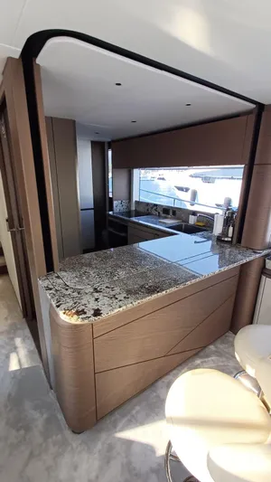  Yacht Photos Pics Luxurious kitchen interior of 2024 Princess X80 yacht with granite countertops and modern design.