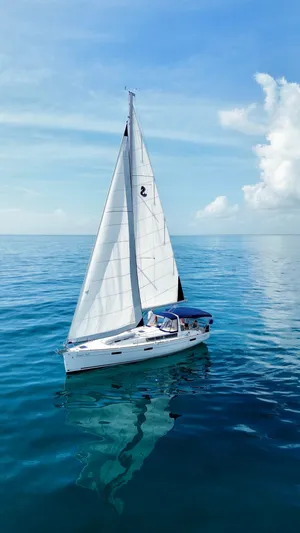 “imagine That” Yacht Photos Pics Beneteau Oceanis 45 sailboat from 2015 on calm blue ocean under clear sky.