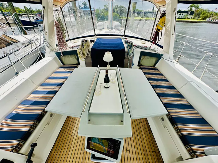 “imagine That” Yacht Photos Pics Cockpit of 2015 Beneteau Oceanis 45 with striped seating and table setup.