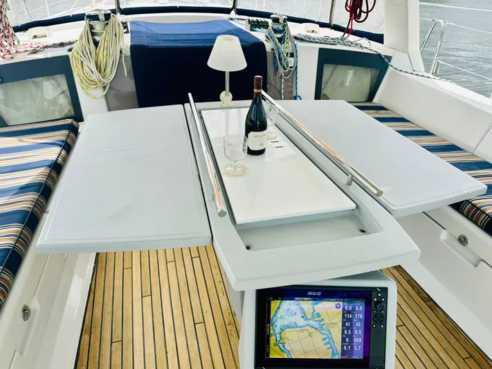 “imagine That” Yacht Photos Pics Beneteau Oceanis 45 cockpit with table, wine, and navigation display, 2015 model.