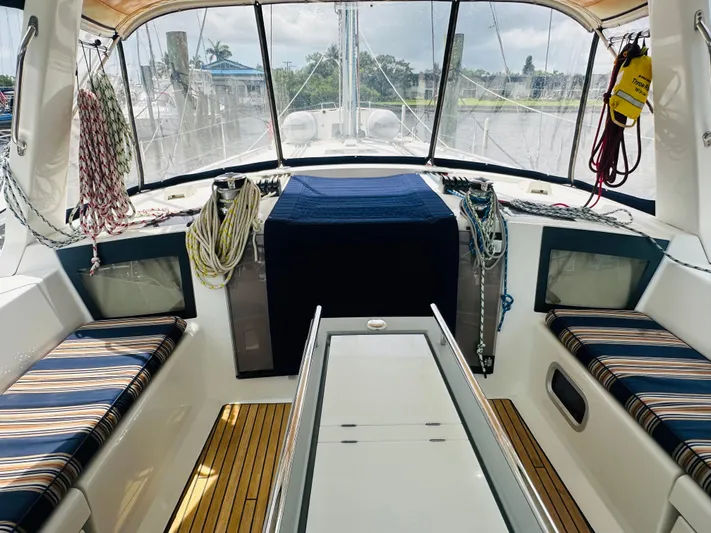 “imagine That” Yacht Photos Pics Interior view of 2015 Beneteau Oceanis 45 sailboat cockpit with striped seating and nautical ropes.