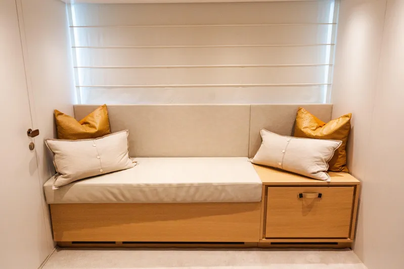 Gatsby Yacht Photos Pics Luxurious seating area on 2021 Sanlorenzo SL96 yacht with cushions and wooden storage.