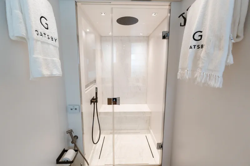 Gatsby Yacht Photos Pics Luxurious shower in 2021 Sanlorenzo SL96 yacht with elegant white towels and modern fixtures.