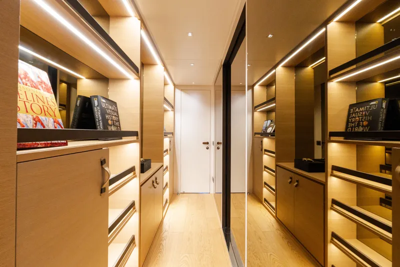 Gatsby Yacht Photos Pics Luxurious interior of 2021 Sanlorenzo SL96 yacht with elegant wooden cabinetry and ambient lighting.